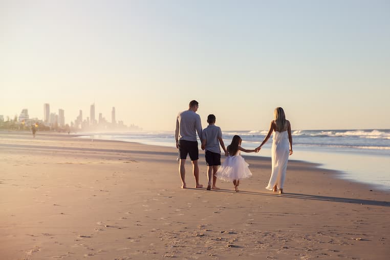 Family walking on Gold Coast beach